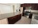 A modern kitchen featuring stainless steel appliances, granite countertops and a central island at 979 Hacienda Cir, Kissimmee, FL 34741