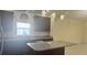 This kitchen has granite countertops, dark cabinets, and a sink near a window at 979 Hacienda Cir, Kissimmee, FL 34741