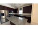 Well-lit kitchen featuring stainless steel appliances, granite countertops and a large center island at 979 Hacienda Cir, Kissimmee, FL 34741