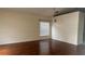 Spacious living room featuring wood floors, white walls, and a window at 979 Hacienda Cir, Kissimmee, FL 34741