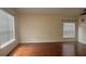 Spacious living room with wood floors, white walls, and window at 979 Hacienda Cir, Kissimmee, FL 34741