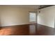 Spacious living room with wood floors, neutral walls, and window at 979 Hacienda Cir, Kissimmee, FL 34741