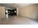 Open-concept kitchen and living room boasts tile flooring and natural light at 979 Hacienda Cir, Kissimmee, FL 34741