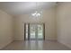 Spacious living room featuring tile floors, high ceilings, and French doors at 979 Hacienda Cir, Kissimmee, FL 34741
