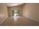 The sunlit living room features tile flooring and sliding glass doors to the backyard at 979 Hacienda Cir, Kissimmee, FL 34741