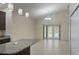 Open living area featuring tile floors, white walls, granite bar and French doors at 979 Hacienda Cir, Kissimmee, FL 34741