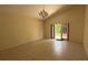 Bright living area featuring neutral paint colors, tiled floors, and sliding door to outdoor area at 979 Hacienda Cir, Kissimmee, FL 34741