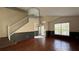 Bright living room showcases hardwood floors, natural light, and a staircase leading upstairs at 979 Hacienda Cir, Kissimmee, FL 34741