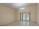 Living room featuring tile floors, white walls, tall ceilings, and French doors to the backyard at 979 Hacienda Cir, Kissimmee, FL 34741