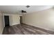 Large main bedroom featuring wood-look floors with a ceiling fan and multiple doorways at 979 Hacienda Cir, Kissimmee, FL 34741