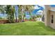 This backyard features a brick wall and lush lawn at 101 Majestic Forest Run, Sanford, FL 32771