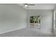 Spacious bedroom featuring carpet floors, ceiling fan, and a glass door overlooking a fenced backyard at 101 Majestic Forest Run, Sanford, FL 32771