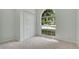 Empty bedroom featuring carpet floors, a large window, and a closet with double doors at 101 Majestic Forest Run, Sanford, FL 32771