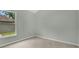 This bedroom features neutral carpet and gray walls with a window at 101 Majestic Forest Run, Sanford, FL 32771