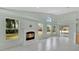 Bright living room with fireplace, many windows, and tile flooring at 101 Majestic Forest Run, Sanford, FL 32771