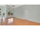 Well-lit living room featuring hardwood floors and a view of the backyard at 101 Majestic Forest Run, Sanford, FL 32771
