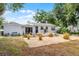 Backyard view of a home with string lights, patio furniture, a grill, minimalist landscaping and a detached garage at 1012 N Shine Ave, Orlando, FL 32803