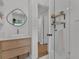 Bright bathroom features modern vanity, decorative mirror, and walk-in shower with white subway tile at 1012 N Shine Ave, Orlando, FL 32803