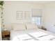 Bright bedroom featuring a queen-size bed, modern minimalist artwork and window with sun-blocking blinds at 1012 N Shine Ave, Orlando, FL 32803