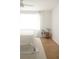 Bright bedroom with light colored carpet, hardwood floors, and minimalist decor at 1012 N Shine Ave, Orlando, FL 32803