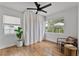 Bright bedroom with hardwood floors, a modern ceiling fan, and two windows providing lots of natural light at 1012 N Shine Ave, Orlando, FL 32803