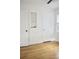 Bedroom featuring hardwood floors, a built-in bookcase, and access to multiple doors at 1012 N Shine Ave, Orlando, FL 32803