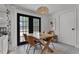 Dining area featuring a rustic wooden table set with stylish chairs, doors that lead to the outside at 1012 N Shine Ave, Orlando, FL 32803