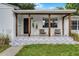 Close-up of the home's front porch with a patterned patio and comfortable seating area at 1012 N Shine Ave, Orlando, FL 32803