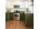 Well-appointed kitchen with wood floors, granite countertops, and stainless steel appliances at 1012 N Shine Ave, Orlando, FL 32803