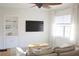 Bright living room featuring neutral tones, built-in shelving, and a large window at 1012 N Shine Ave, Orlando, FL 32803