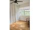Cozy living room featuring a large window, minimalist chair, and light colored hardwood floors at 1012 N Shine Ave, Orlando, FL 32803