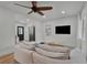 Modern living room featuring a large sofa, a television, and open access to the kitchen at 1012 N Shine Ave, Orlando, FL 32803