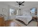 Relaxing main bedroom showcasing modern ceiling fan, two large windows and hardwood flooring at 1012 N Shine Ave, Orlando, FL 32803