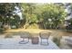 Inviting outdoor seating area featuring stylish wicker chairs, a small accent table, and a lovely green backdrop at 1012 N Shine Ave, Orlando, FL 32803