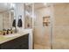 Bathroom featuring tiled shower with glass door, granite counter and modern fixtures at 102 Royalty Cir, Sanford, FL 32771