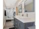 A gorgeous bathroom with double sink vanity, a framed mirror, and a glass enclosed shower with marble tile at 102 Royalty Cir, Sanford, FL 32771