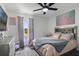 The bedroom is well-lit by a ceiling fan and features a window with decorative curtains at 102 Royalty Cir, Sanford, FL 32771