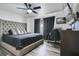 Bedroom showcasing tufted headboard, ceiling fan, gray wood floors and dark gray curtains at 102 Royalty Cir, Sanford, FL 32771