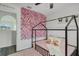 This is a bedroom featuring flower wall art, a metal framed bed, and hardwood floors at 102 Royalty Cir, Sanford, FL 32771