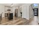 Open kitchen and entrance featuring updated appliances and wood flooring at 102 Royalty Cir, Sanford, FL 32771