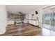 Bright living room with stylish accent wall, hardwood flooring, modern furnishings and sliding doors at 102 Royalty Cir, Sanford, FL 32771