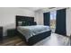 This is a main bedroom featuring hardwood floors, a large window, and a well-made bed and headboard at 102 Royalty Cir, Sanford, FL 32771