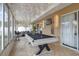 Large sun room featuring tile floors, pool table, sectional couch, tv and bar stools at 102 Royalty Cir, Sanford, FL 32771