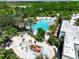 Aerial view of a community water park and pool with lush tropical landscaping at 1067 Plantation Ln, Davenport, FL 33896