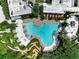 Stunning aerial view of a community pool, mini-golf, cabanas, and other amenities surrounded by lush landscaping at 1067 Plantation Ln, Davenport, FL 33896