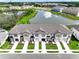 Beautiful aerial view of new townhomes in a lakeside community at 1067 Plantation Ln, Davenport, FL 33896
