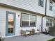 Relaxing back patio with outdoor seating, offering a tranquil space to unwind with neutral siding at 1067 Plantation Ln, Davenport, FL 33896