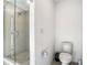 Bright bathroom featuring a toilet and tiled shower with a glass door at 1067 Plantation Ln, Davenport, FL 33896