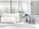 Modern bathroom featuring a stylish chrome faucet, quartz countertop and white towels at 1067 Plantation Ln, Davenport, FL 33896