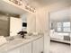 Bright bathroom with dual vanity sinks and a view into the bedroom at 1067 Plantation Ln, Davenport, FL 33896